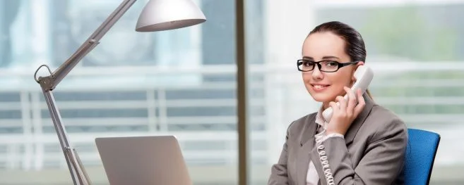 Executive Woman At Desk Talking On Phone