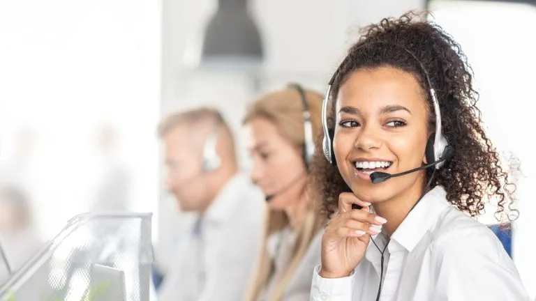 Call Center Agent Smiling and Talking on Headset